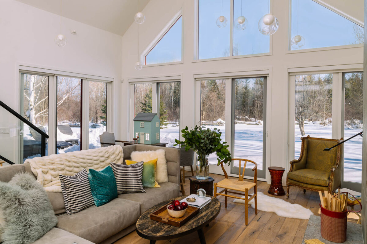 Buying a Home in Southern Georgian Bay- beautiful living room with a view of the outdoors covered in snow