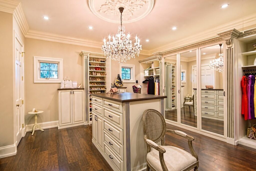 huge walk-in closet with shelving and central cabinetry