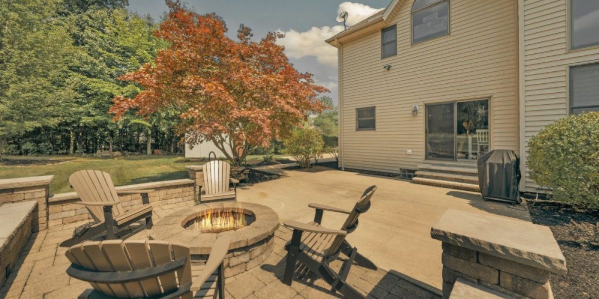 Outdoor upgrades for property value with landscaping and patio